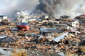A large fire in the background of a city.