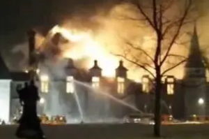 A large fire burning in the middle of a building.