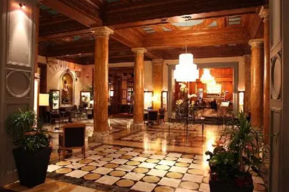 A large lobby with wooden columns and tile floors.
