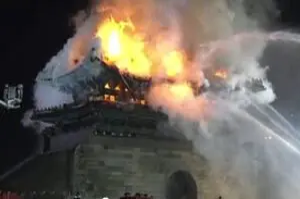 A fire is burning in the sky above a building.