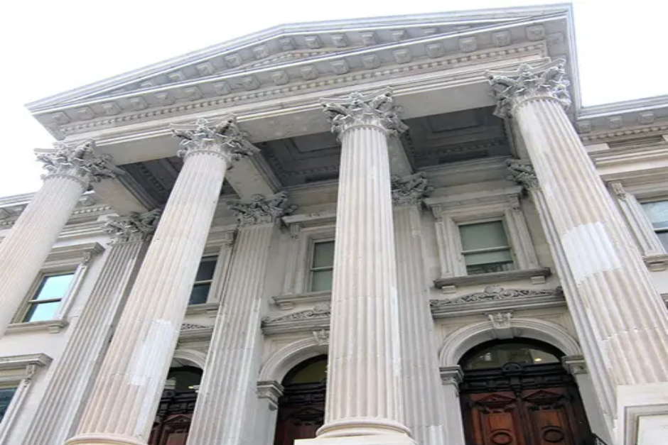 A large building with columns and pillars on the front.